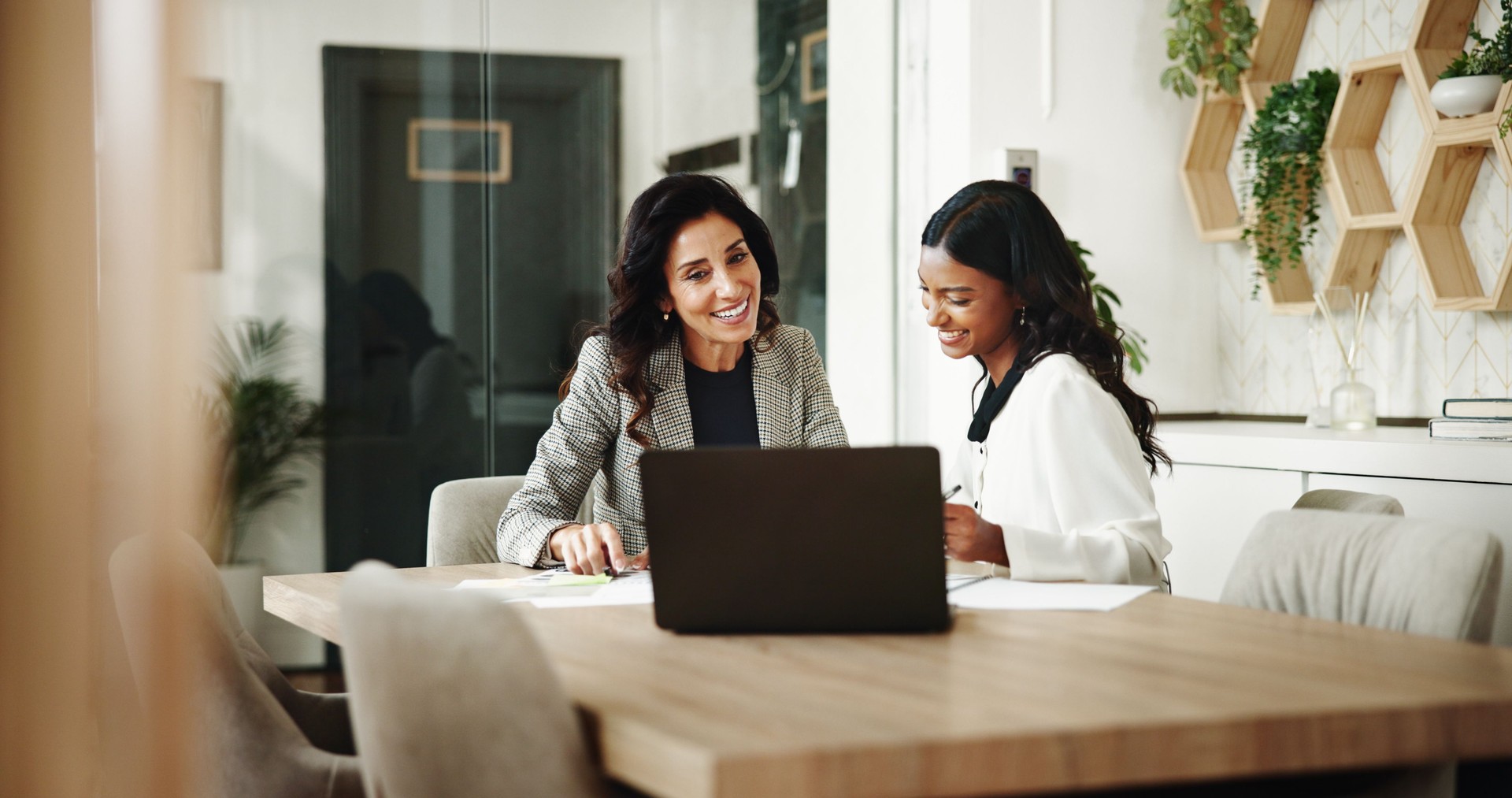 Meeting, women and business people with laptop in office, investment project and discussion. Teamwork, accountant and financial advisor with feedback for finance update, report review and documents
